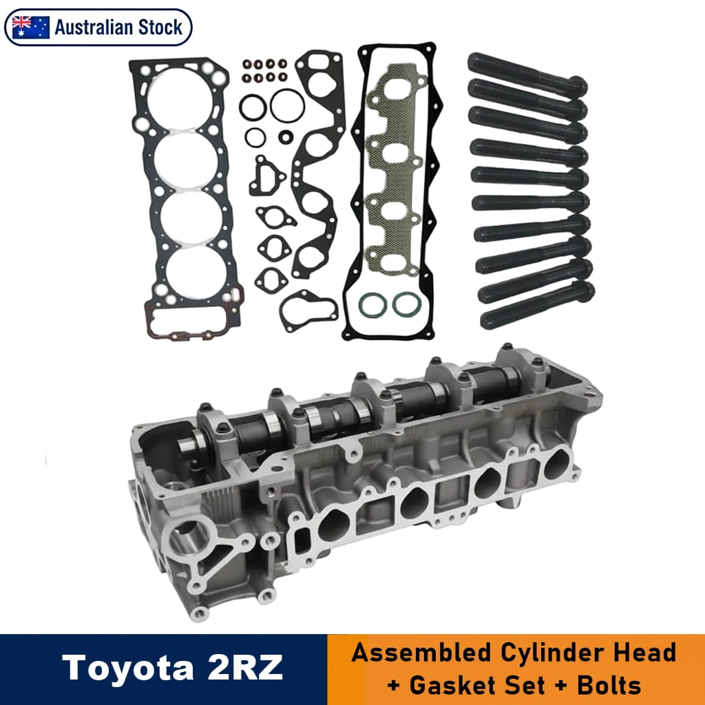 Toyota 2RZ assembled cylinder head kit shown on a white background, including the metal cylinder head, gasket set, and black installation bolts. Text at the bottom reads 'Toyota 2RZ' and 'Assembled Cylinder Head + Gasket Set + Bolts'.