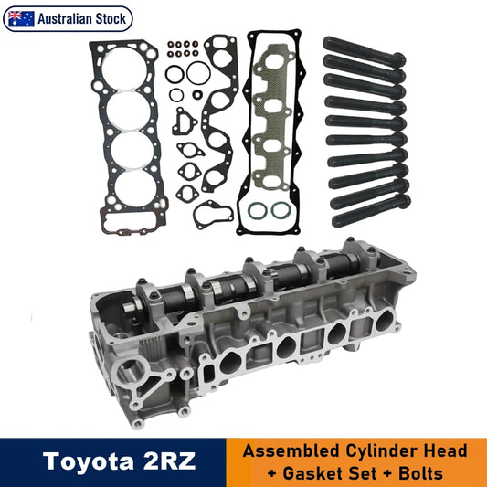 Toyota 2RZ assembled cylinder head kit shown on a white background, including the metal cylinder head, gasket set, and black installation bolts. Text at the bottom reads 'Toyota 2RZ' and 'Assembled Cylinder Head + Gasket Set + Bolts'.