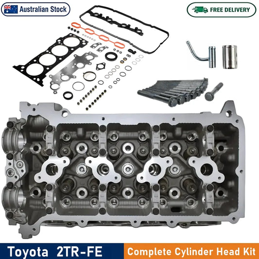 Toyota 2TR-FE complete cylinder head kit with the large metallic engine head shown prominently, along with gaskets, seals, washers, bolts, and other installation parts arranged above it on a white background. Text banners indicate Australian Stock and Free Delivery.