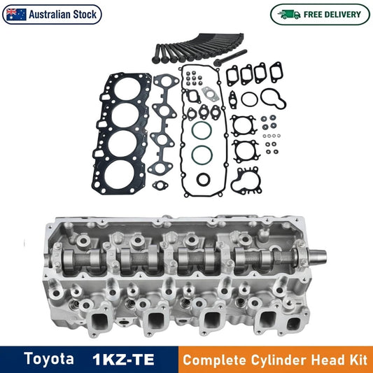 Toyota 1KZ-TE complete cylinder head kit shown on a white background, featuring the silver metal cylinder head above and its gasket set arranged below. Prominent text banners at the top and bottom indicate 'Australian Stock ' and 'Toyota 1KZ-TE Complete Cylinder Head Kit'.